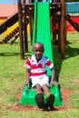 African kids playing on slides and other park equipment at local public playground Royalty Free Stock Photo