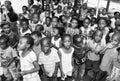 Young African Preschool kids singing songs in the playground of