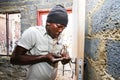 African builder working on a Community Outreach program to build a small affordable house in local township