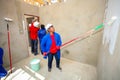 Diverse Community members painting a low cost house in Soweto