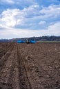 Sowing campaign in the field in early spring. Tractor with seeder