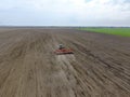 Sowing of corn. Tractor with a seeder on the field. Using a seeder for planting corn.