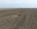 Sowing of corn. Tractor with a seeder on the field. Using a seeder for planting corn.