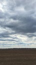 Sowing time in Ukraine during the war. Preparing fields for sowing grain. Blue sky, plowed land. terror.