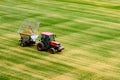 Sowing tractor renovating faded grass at the empty soccer stadium