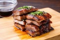 soy-based marinade seeping into stacked pork belly slices