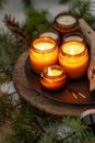 Soy candles burn in glass jars. The evening is dark. Aromatherapy and relaxation. Comfort at home. Candle in a brown jar