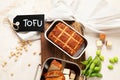 Soy food. Baked tofu cheese on a board, soybeans. Vegan product