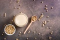 Soy milk in a glass and soybeans in a bowl on the table. Lactose free drink. Top view Royalty Free Stock Photo