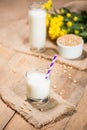 Soy milk or soya milk and soy beans on wooden table. Royalty Free Stock Photo