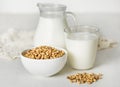 Soy milk and soybeans on a white table