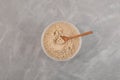 Soy Protein isolate in plastic container, top view. Pure powder isolated from soybean. Soy protein isolate is often used in meat