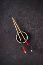 Soy sauce bowl and bamboo chopsticks on black background. Asian cuisine concept Royalty Free Stock Photo