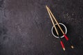 Soy sauce bowl and bamboo chopsticks over black background. Asian cuisine concept Royalty Free Stock Photo