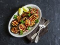 Soy sauce and ginger marinated grilled eggplant on a dark background, top view. Delicious vegetarian appetizer or snack.