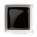 Soy sauce in a square bowl isolated