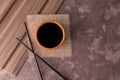 Soy sauce in a wooden bowl and chopsticks on a gray background. Copy space. Royalty Free Stock Photo