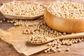 Soybean seeds in a wooden spoon, placed on a wooden table, seeds or natural healthy food - top view