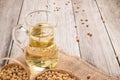 Soybean and soybean oil in jar on wood Royalty Free Stock Photo