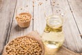 Soybean and soybean oil in jar on wood Royalty Free Stock Photo