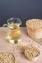 Soybean and soybean oil in jar on wood Royalty Free Stock Photo