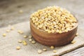 Soybean in a wooden bowl agricultural products on the sack background - Peeled Split Soybean or Soya Bean without husk