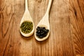 Soybeans and black beans in wooden spoons Royalty Free Stock Photo