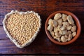 Soybeans meat, chunks in a brown ceramic bowl. Raw soybeans chunks on rustic wooden background