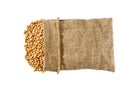 soybeans in sack isolated on white background. Grains are scattered out of the bag, top view Royalty Free Stock Photo