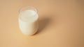 Soymilk in glass on yellow background. no people.