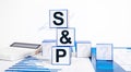 SP 500. Stock market, investment and finance concept. Cubes with Standard and Poor index abbreviation, calculator and Royalty Free Stock Photo