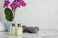 Spa accessories and blooming  on marble table against light background, space for text Royalty Free Stock Photo