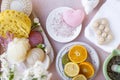 Spa accessories, flowers and fruits. pink background. Copy space