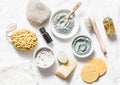 Spa accessories - nut scrub, sponge, facial brush, natural soap, clay face mask, pumice stone, essential oil on a light background