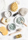 Spa accessories - nut scrub, sponge, facial brush, natural soap, clay face mask, pumice stone, essential oil on a light background Royalty Free Stock Photo