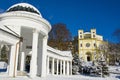 Spa architecture in winter - colonnade of mineral spring Karolina and catholic church - Marianske Lazne Marienbad Royalty Free Stock Photo