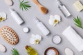 Spa, aromatherapy, beauty treatment and wellness background with massage brush, towel, orchid flowers and cosmetic products.
