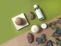 Spa aromatherapy flat lay with bath bombs, cosmetic bottles and mineral stones. Trendy  green and beige background. Royalty Free Stock Photo