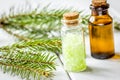 Spa with organic spruce oil and sea salt in glass bottles on white table background Royalty Free Stock Photo