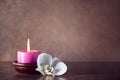 Spa aromatic birning candle decorated with white orchid Royalty Free Stock Photo