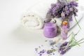 Lavender flowers, soap, candle, skin oil and white towels on the white background. Spa aroma therapy, skin care Royalty Free Stock Photo