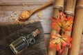 Spa background with bamboo, bath salt, massage oil, autumn leaves and towel