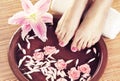 Spa background with beautiful feet, flowers and petals Royalty Free Stock Photo