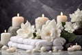 Spa background in a brown shade - white towels, aroma candles, stones for a relaxing massage and white flowers