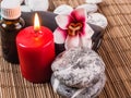 Spa background with red candle, massage oils and stones Royalty Free Stock Photo