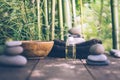 Spa background with woman`s hands and clear water on an old wooden table. Japanese style. Simplicity, Zen, relax.