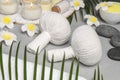 Spa bags, stones and orchid flowers on light gray table Royalty Free Stock Photo