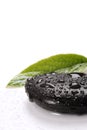 Spa basalt stones and green leaves with water drops Royalty Free Stock Photo