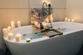 Spa bath with flowers, candles and tray Royalty Free Stock Photo