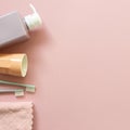 Spa bathroom products. Shampoo bottle, cup, toothbrush, towel on pink background Royalty Free Stock Photo